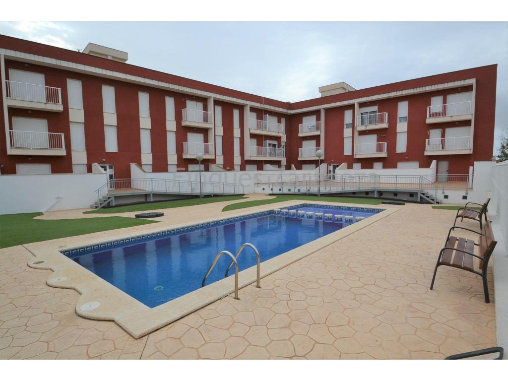 Sant Jaume d'Enveja is a town of just over 3.000 inhabitants located in the centre of the Natural Park of the Ebro Delta, next to the river Ebro and only a few minutes drive from the beach.This is a first floor flat of 57m² constructed area and 49m² usable area. Comprising of hallway, bathroom, kitchen, lounge/dining room, two bedrooms and balcony overlooking the communal pool and garden.In addition, this flat enjoys a parking space on the first floor of the building.The flat is equipped with ceramic hob, electric oven and boiler, air conditioning (hot/cold), and double glazed aluminium windows.