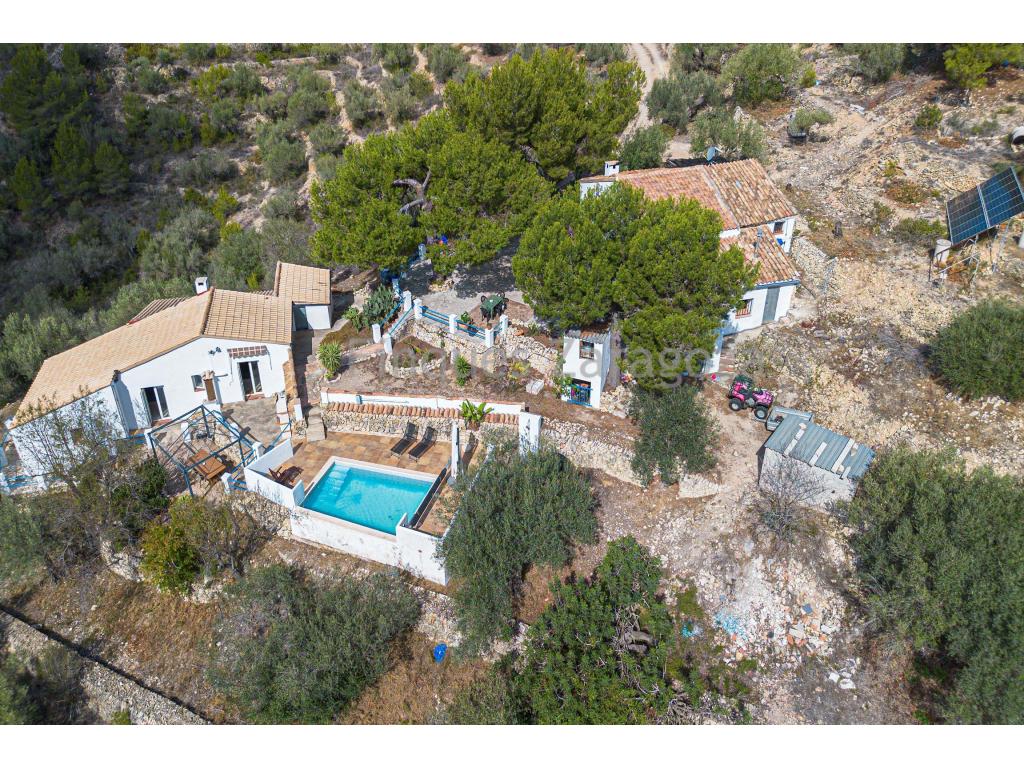 This beautiful finca is located in the area of Perello, 8km from the town of l'Ampolla and the beach, in a quiet and noise free area.The plot has 37.472m² of land and is planted with olive trees, carob trees and various fruit trees.The road to the finca is completely asphalted. Once we arrive at the finca, there is a private road which leads directly to the houses.The first house we find on the left hand side is a listed farmhouse from 1913. It has 141,61m² constructed and 94,71m² usable. It has been completely renovated and is distributed internally in kitchen, lounge/dining room, a room used as an office and bathroom on the ground floor. Stairs lead to the first floor where we find another bathroom with bathtub and three double bedrooms. From the main bedroom we have access to a porch terrace.It is equipped with gas cooker and boiler, heating by gasoil radiators and fireplace.The second house, built on a lower level than the first one, has a more modern style. It has 127,46m² constructed area and 89,47m² usable area. In the lower part of the house we find the kitchen, through interior stairs we access to the hallway and from here to the living room of the house which gives access to a bedroom, and again from the hallway, to the other two bedrooms and bathroom. All the rooms, except the bathroom and the small bedroom (the one next to the living room), have access from the outside. The house has plenty of natural light.It is equipped with gas cooker and boiler, double glazed aluminium windows and water heating system from the fireplace.Attached to the house, there is a small storeroom which is currently used as a laundry room.The roof of both houses is gable with Arabic tiles.Outside there are several storage rooms and a swimming pool overlooking the rest of the property.The property is not in production.It has electricity by means of solar panels and batteries.It has water from a cistern (23.000 litres capacity).